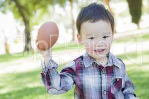 Cute Young Mixed Race Boy Playing Football Outside
