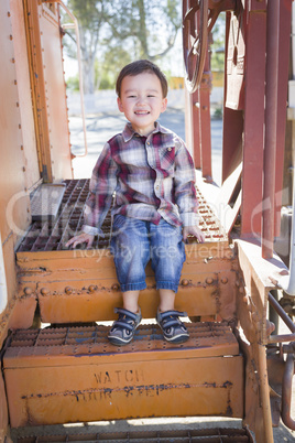 Cute Young Mixed Race Boy Having Fun on Railroad Car