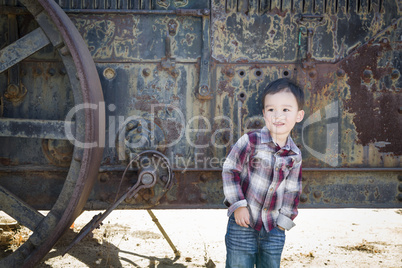 Cute Young Mixed Race Boy Having Fun Near Antique Machinery