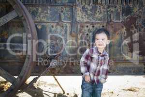 Cute Young Mixed Race Boy Having Fun Near Antique Machinery