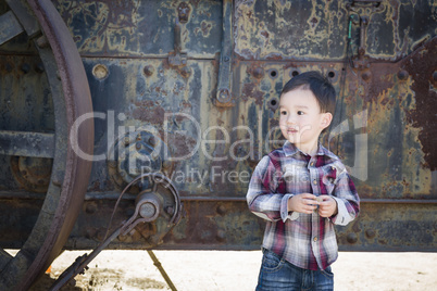 Cute Young Mixed Race Boy Having Fun Near Antique Machinery