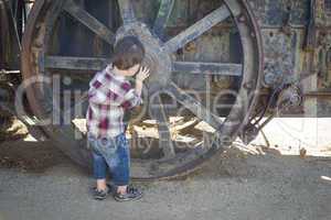 Cute Young Mixed Race Boy Having Fun Near Antique Machinery