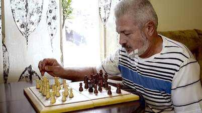 Senior playing chess