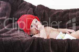 Surprising baby boy over brown blanket