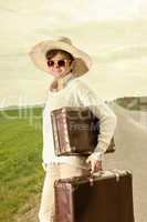 Woman running on the road and wearing holiday suitcase