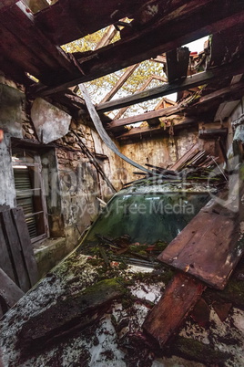 Damaged car in old wooden caban