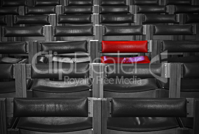 Single red chair in amongst monochrome chairs