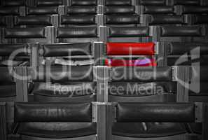 Single red chair in amongst monochrome chairs