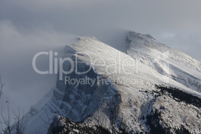 Snow blowing off the top of a mountain ridge in the rockies