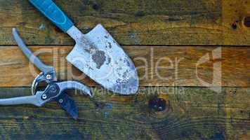 gardening tools on rustic wooden boards