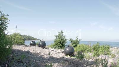 Three big sea mines found on the rocky shore of the sea FS700 Odyssey 7Q 4K