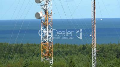 Two tall telecommunication towers in the middle of the field GH4 4K