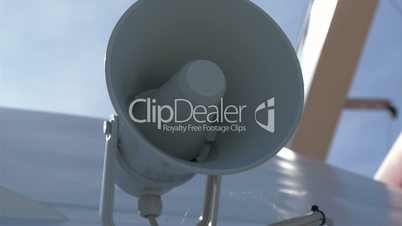 A white small megaphone attached on the yacht GH4 4K