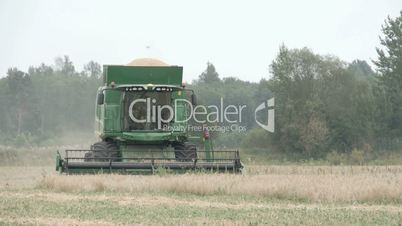 A wheat harvester running on the field
