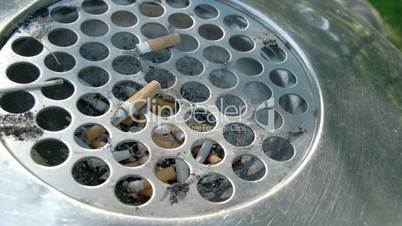 A cigarette bin or ahstray with lots of cigs inside FS700 4K