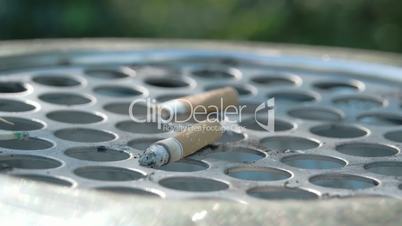Close up view of the cigarette butt on the bin FS700 4K