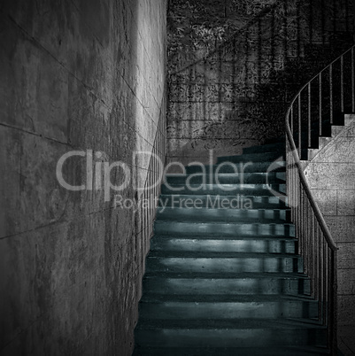Spooky old stone interior staircase with rusty handrail