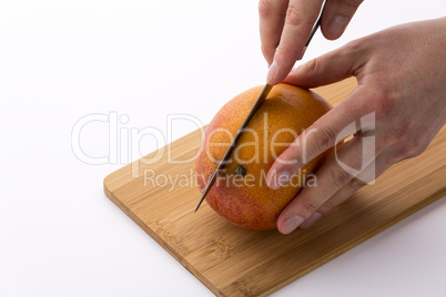 Kitchen Knife Sinking Into Mango For A First Cut