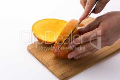 Knife Positioned For A Second Cut Through A Mango
