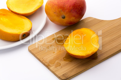 Juicy Mango Slice On A Wooden Cutting Board