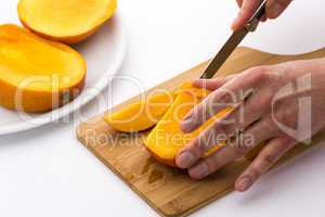 Juicy Fruit Chip Being Sliced Off A Mango Third