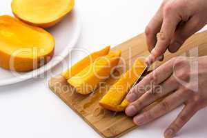 Mango Slice Being Cut Into Four Fruit Chips