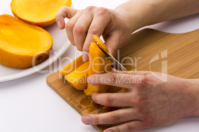 Peeling Off The Fruit Flesh From The Mango Skin