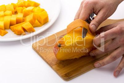 Peeling The Mango Slice Containing The Fruit Pit