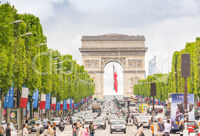 PARIS - JULY 20, 2014: Tourists walk along Champs Elysees in Par