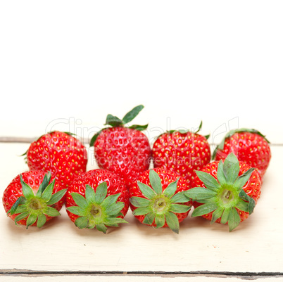 fresh organic strawberry over white wood