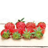 fresh organic strawberry over white wood