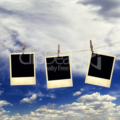 Old instant photos on the background of the sky with clouds