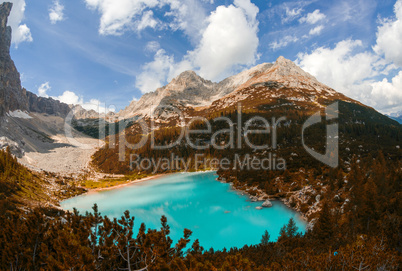 Stunning azure color of mountain lake surrounded by vegetation a