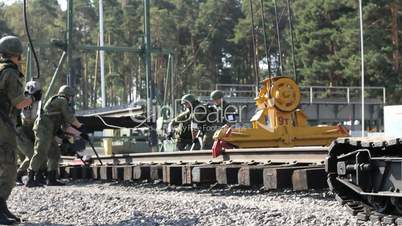 Military Men and Railroad track installation machine.