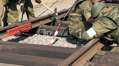 Soldiers are connecting railroads. Close Up.