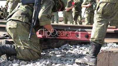 Russian Soldiers are connecting rail of railway.