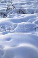 Snow drifts in snowbound winter meadow