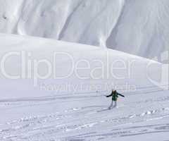 Snowboarder downhill on off piste slope with newly fallen snow