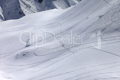 Top view on snowy off piste slope with trace from ski and snowbo