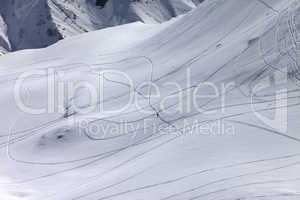 Top view on snowy off piste slope with trace from ski and snowbo