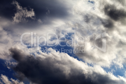 Blue sky with dark clouds