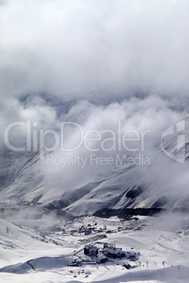 Top view on ski slope and hotels in mist