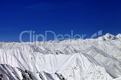Snowy winter mountains in sun day
