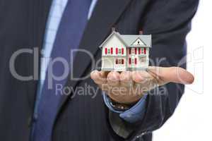 Male Real Estate Agent Holding Miniature House in Palm