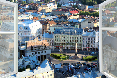 opened window to the roofs of city