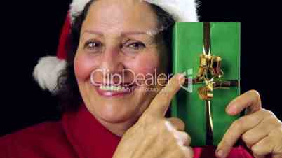 Senior Santa Claus Lady Showing Wrapped Green Gift