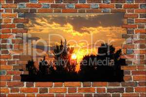 broken brick wall and view to the sunset
