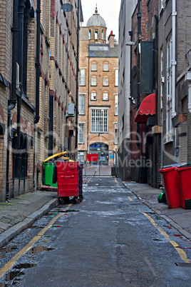 Looking down an empty inner city alleyway