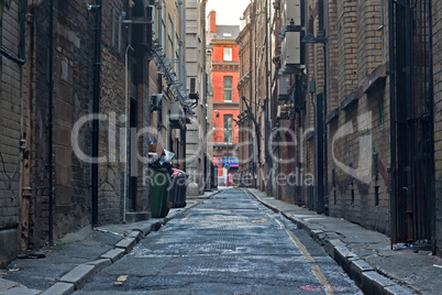 Looking down an empty inner city alleyway