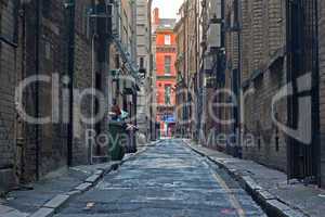 Looking down an empty inner city alleyway